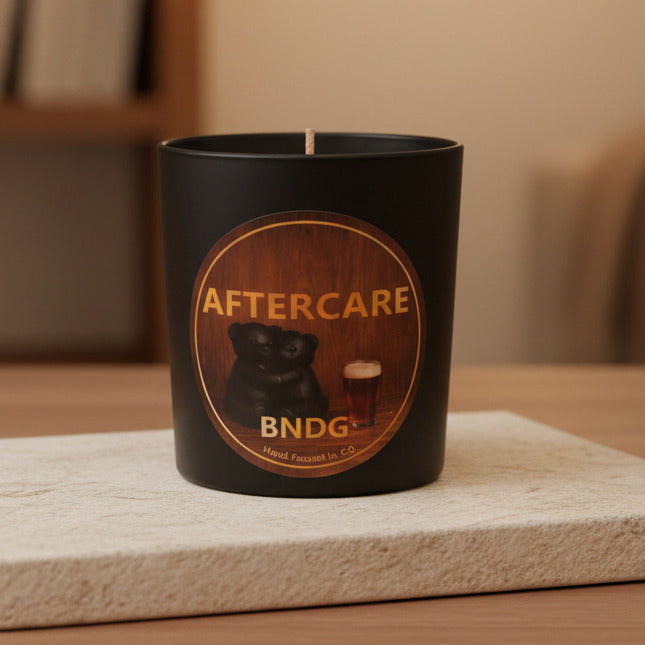 black candle jar on stone in living room