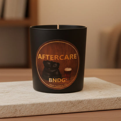 black candle jar on stone in living room