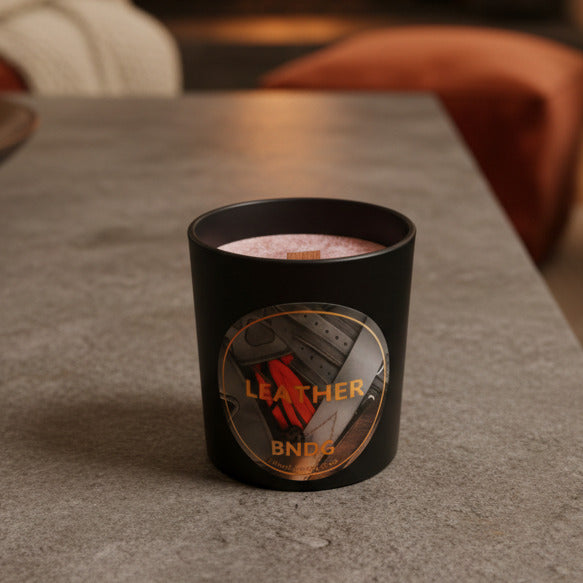 black jar candle on stone surface in cozy living room