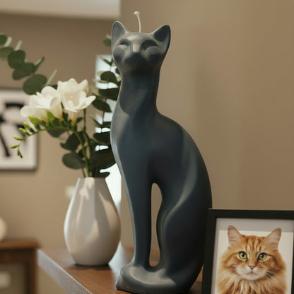 a dark grey modern cat candle on a shelf with flowers and a cat photo