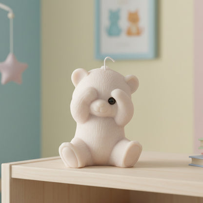 a beige peek-a-boo teddy bear candle on a shelf in a nursery