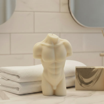a white male torso candle on a bathroom counter