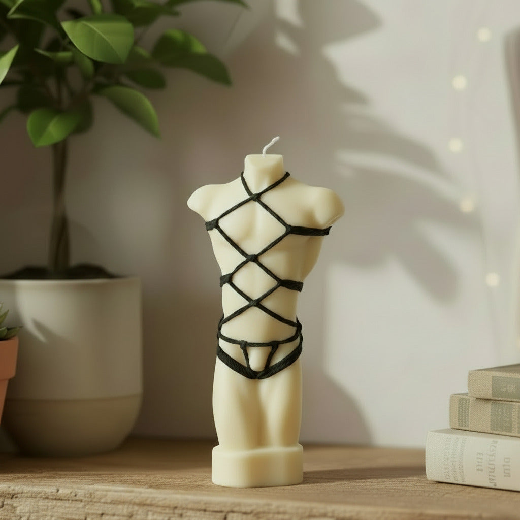 white male torso candle with black shibari rope harness on a shelf