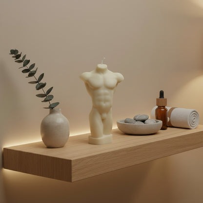 a white male torso candle on a shelf 