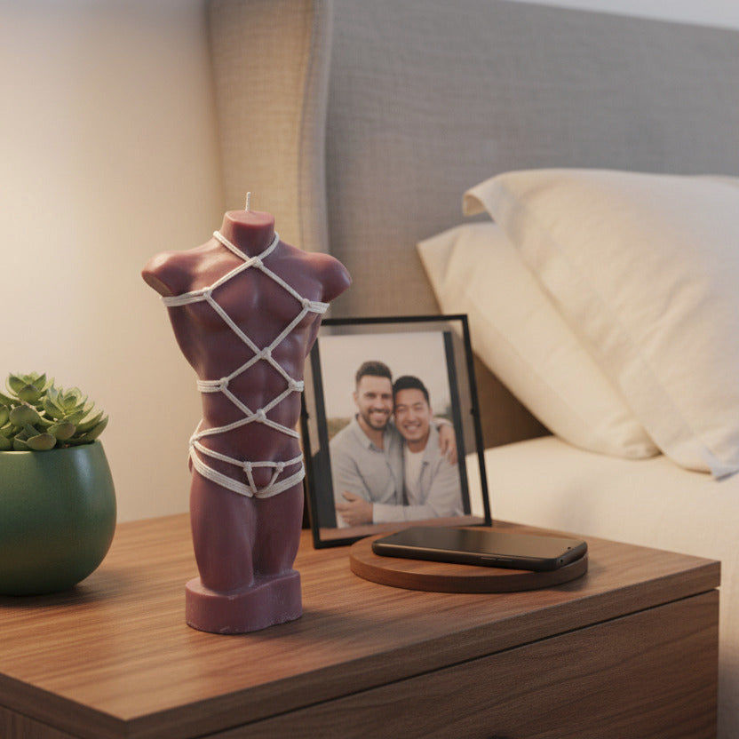 brown male torso candle with shibari rope harness on a nightstand