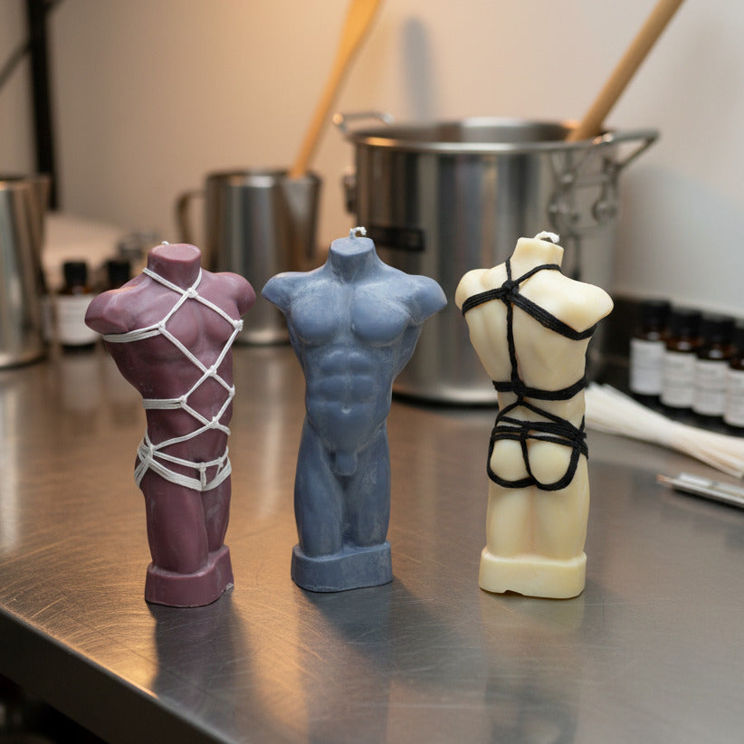 Three male torso candles in different colors with and without shibari rope harness in candle making room