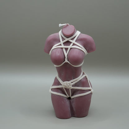 brown female torso candle with white shibari rope harness with grey background