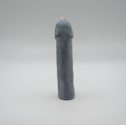 dark grey penis pillar candle on light grey background