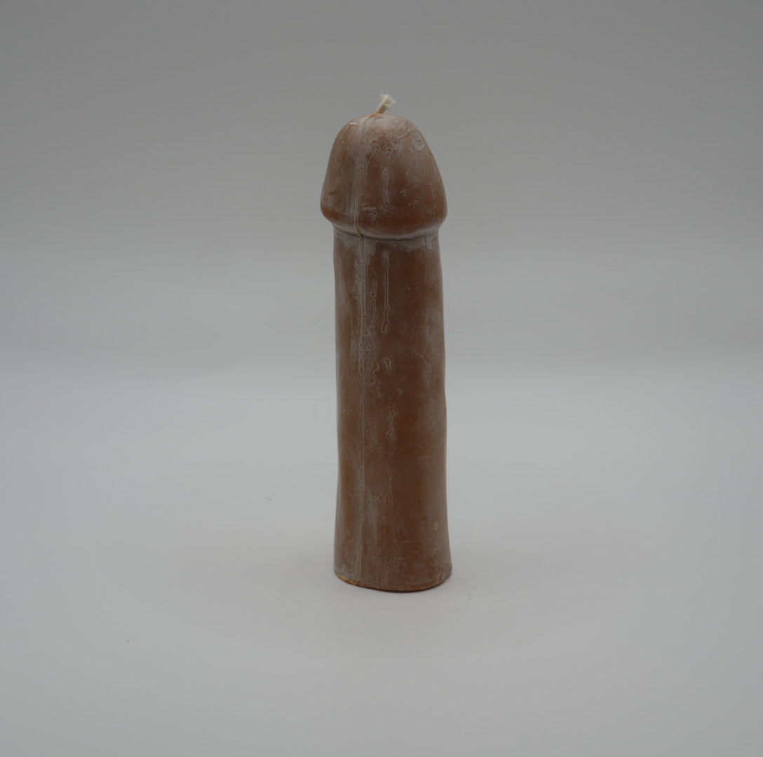 brown penis pillar candle on grey background
