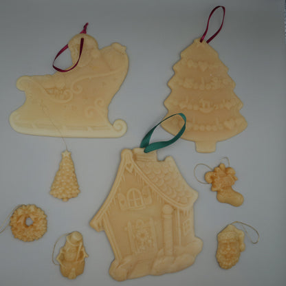 7 different styles of beeswax ornaments for christmas tree on grey background