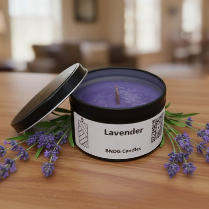 a "lavender"-scented candle tin on a table in a living room, surrounded by lavender flowers.
