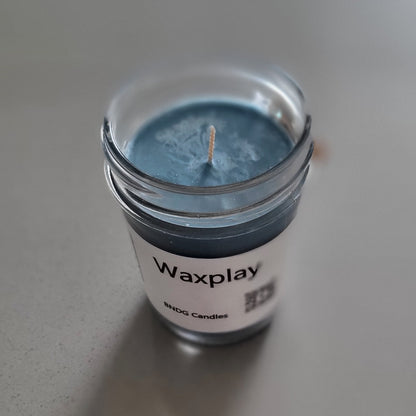 Small container of blue wax with a visible brand label on a light gray background