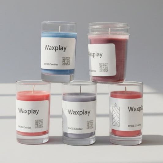 Five 'Waxplay' candles with labels on a surface.